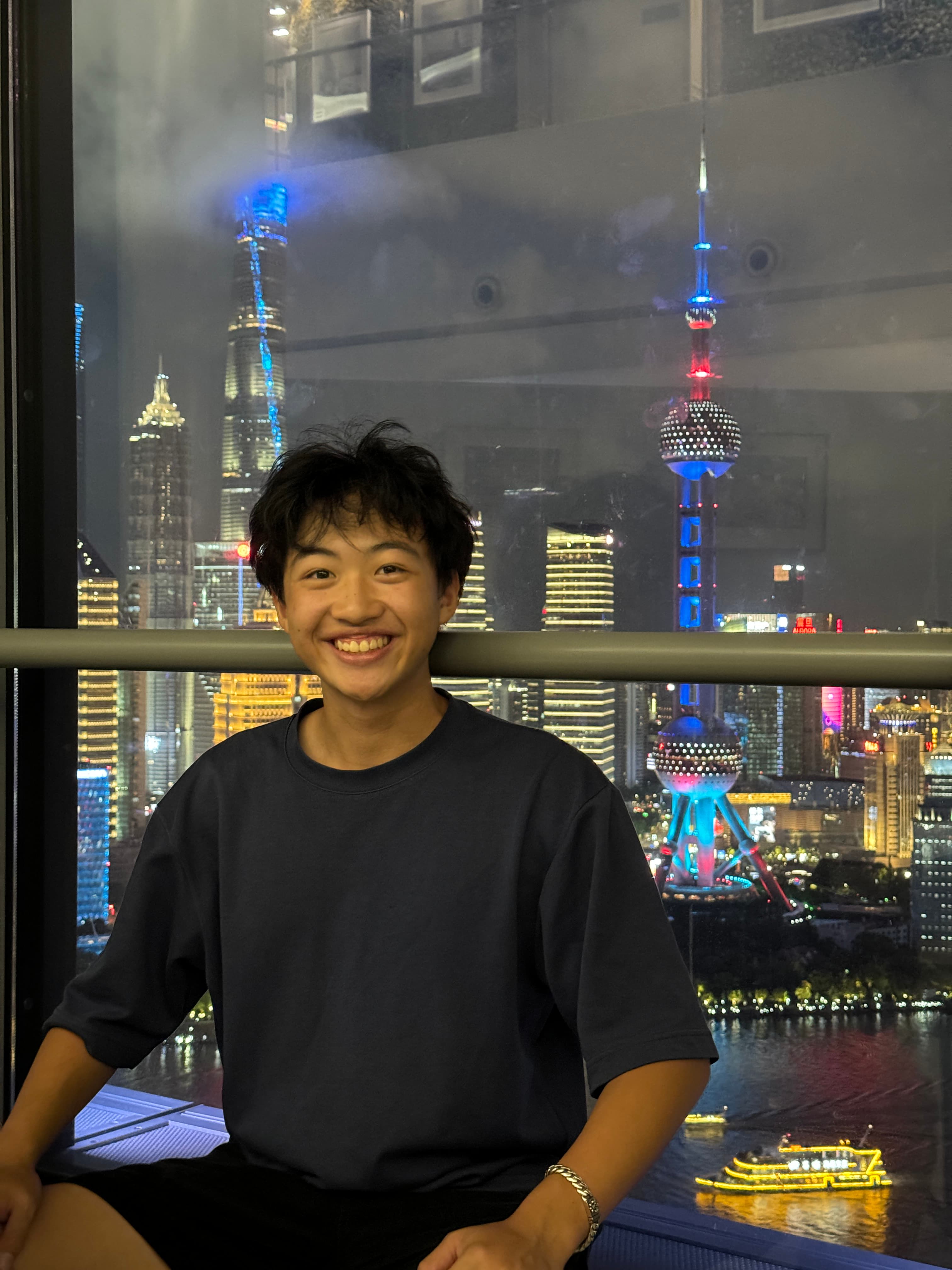 Jaden with the illuminated Shanghai skyline behind him