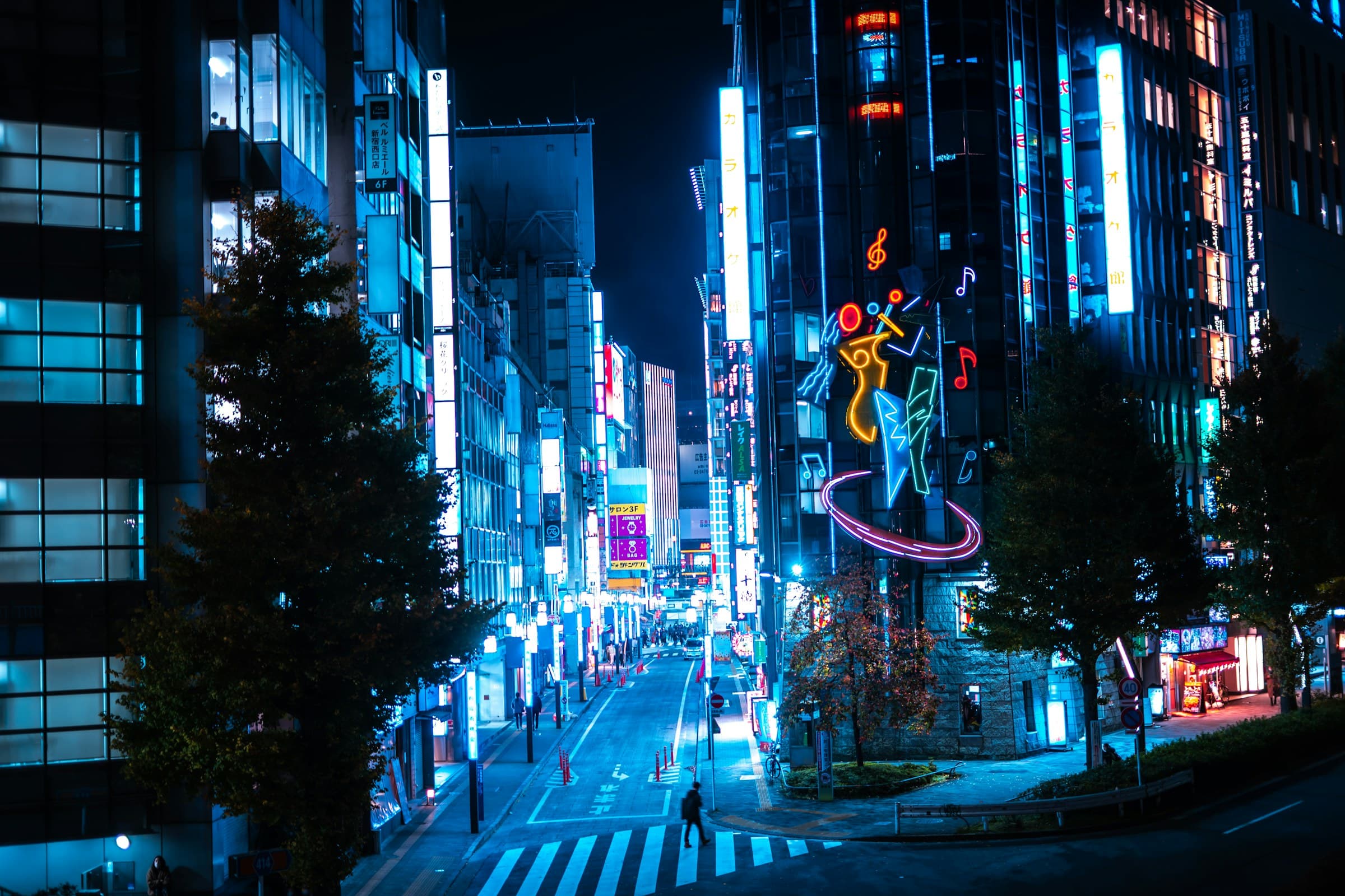 A neon-lit Tokyo street glowing blue after dark