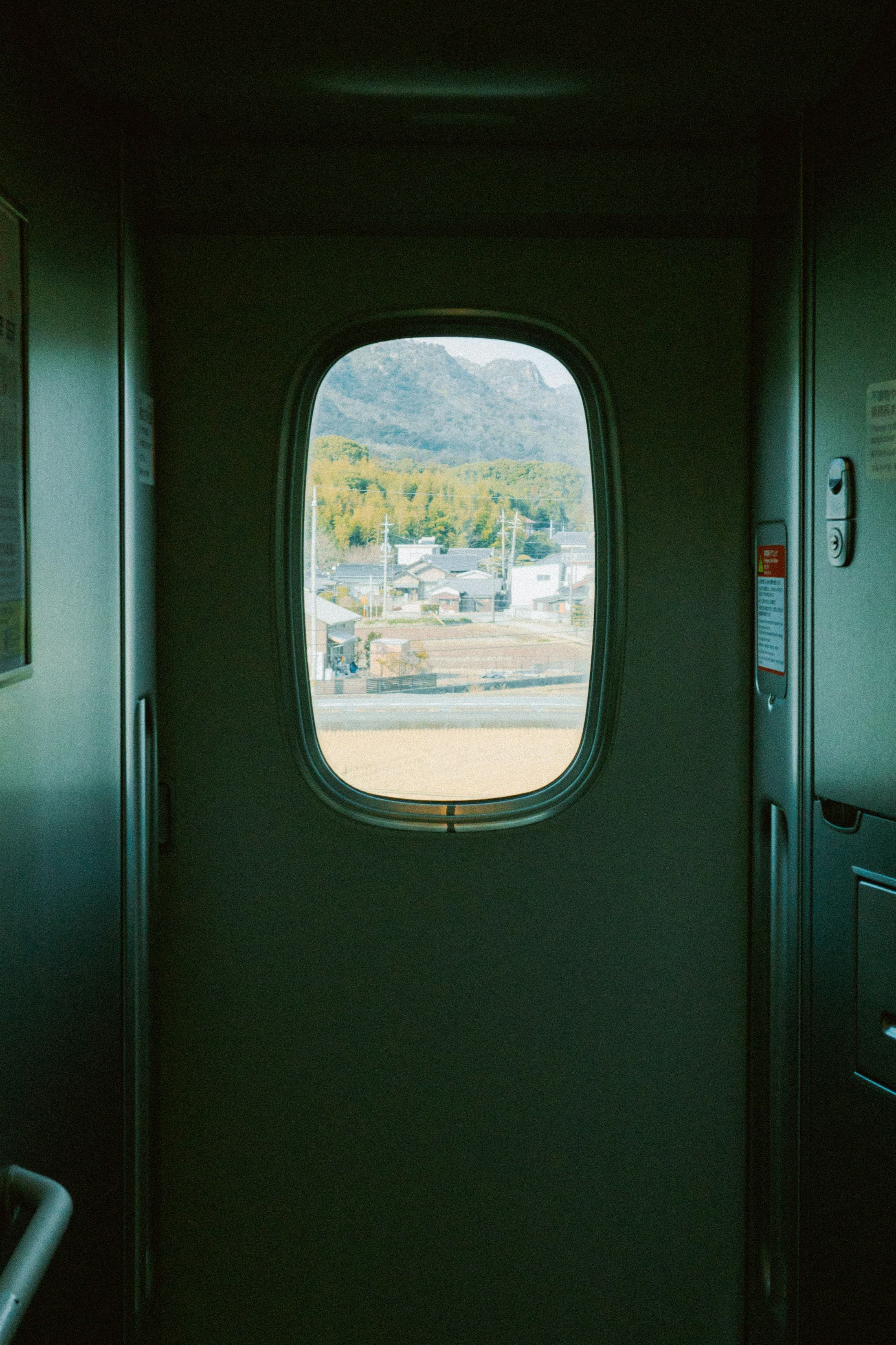 A Japanese landscape framed by a train window